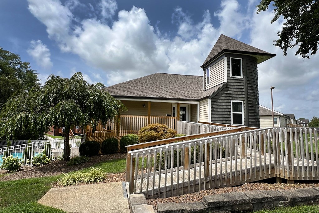 a house with a white fence in front of it at 450 on Keeneland Apartments, Richmond, Kentucky