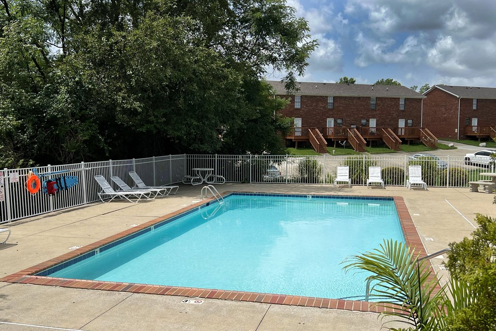 a swimming pool with chairs at 450 on Keeneland Apartments, Richmond