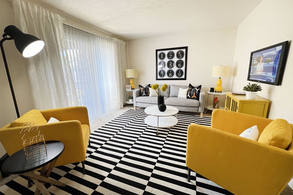 a living room with yellow furniture and a checkered floor at Miamisburg by the Mall, Miamisburg, 45342