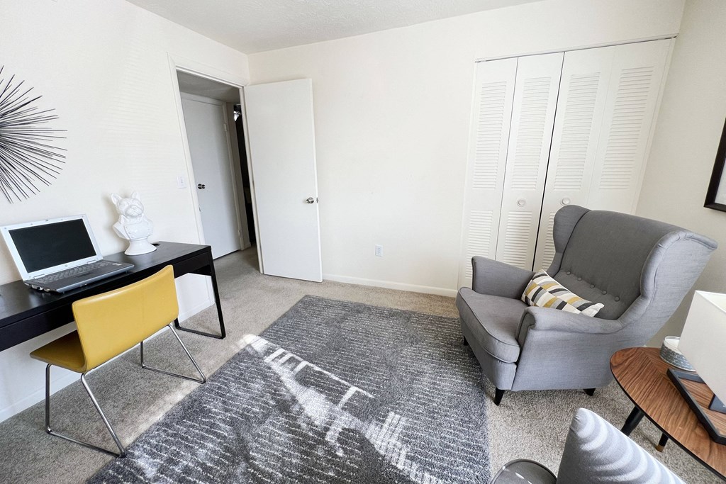 a living room with a chair and a desk with a laptop at Miamisburg by the Mall, Miamisburg, OH, 45342