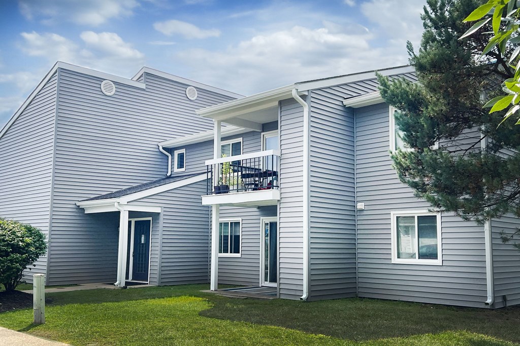 a white house with a yard and a balcony at Deercross Apartments, Cincinnati, Ohio