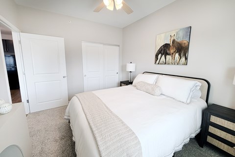 Guest bedroom with horse artwork and white linens at The Meridian on 32 Apartments, Ohio, 45103