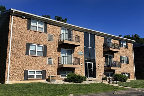 A brick building with balconies and the number 1760 on the door.