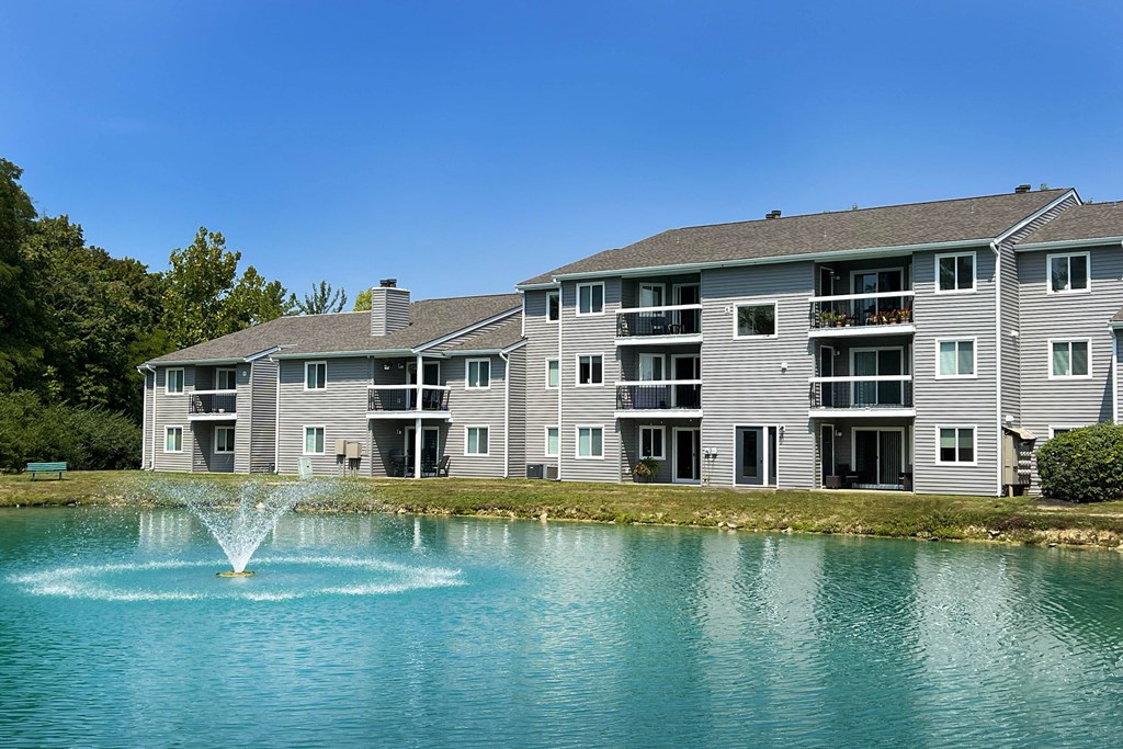 a fountain in a lake in front of an apartment building at Deercross Apartments, Cincinnati, Ohio