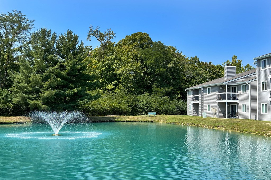 a fountain in the middle of a pond in front of an apartment building at Deercross Apartments, Ohio, 45236