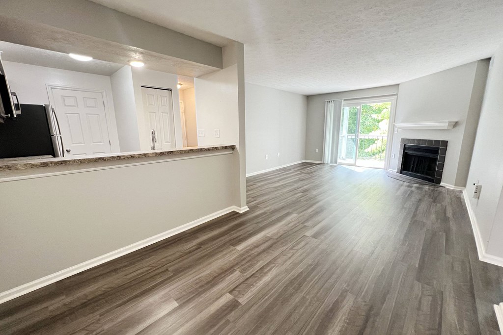 an empty living room with wood flooring and a fireplace at Deercross Apartments, Ohio, 45236