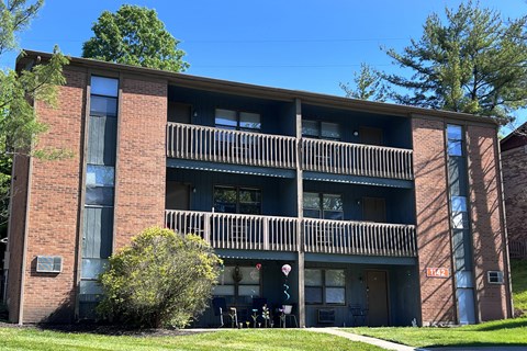 A large brick building with a balcony in the middle.