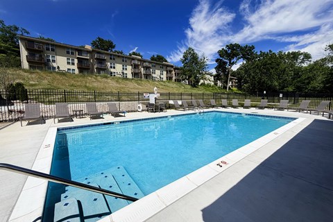 A large swimming pool with a metal railing around it.