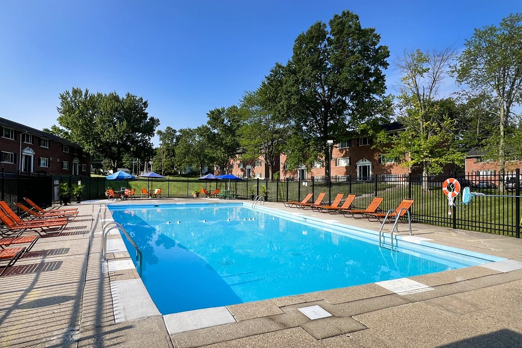 a swimming pool with chairs around it in front of a building at Sharondale Woods Apartments, Cincinnati, 45241