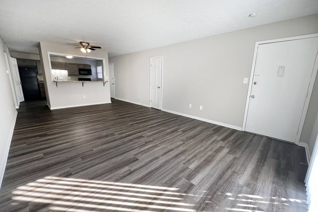 an empty living room with wood flooring and a ceiling fan at Revere Village Apartments, Centerville, OH, 45458