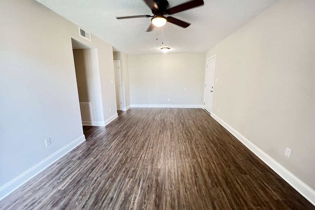 an empty living room with wood flooring and a ceiling fan at 450 on Keeneland Apartments, Kentucky, 40475