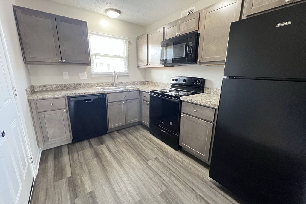a kitchen with wood flooring and stainless steel appliances at Revere Village Apartments, Centerville, 45458