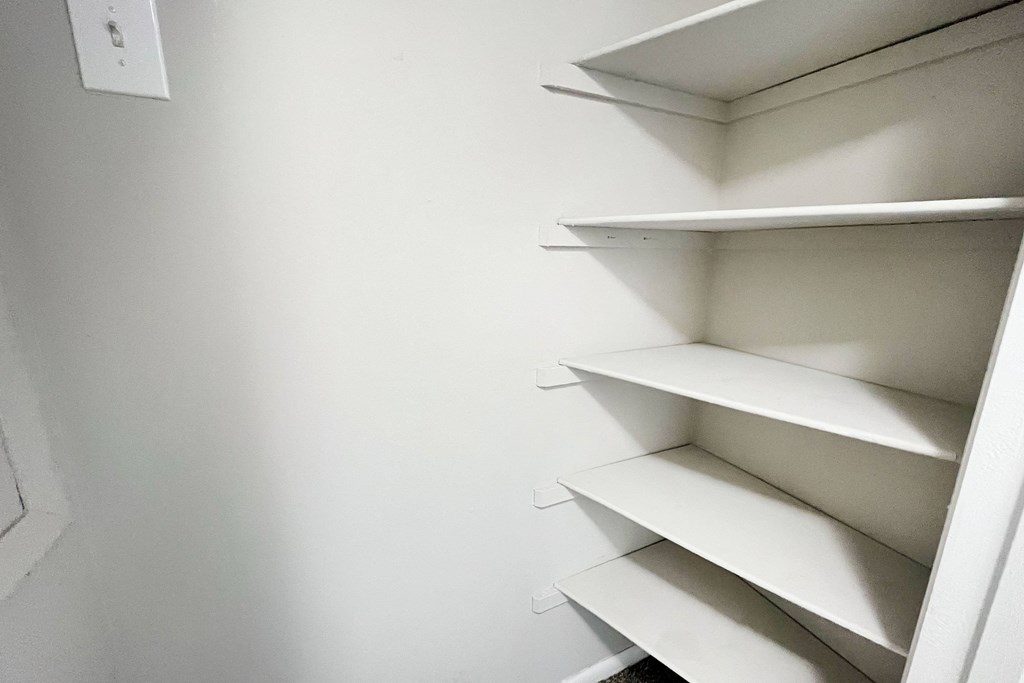 a small closet with white shelves and a white wall at Revere Village Apartments, Centerville, Ohio
