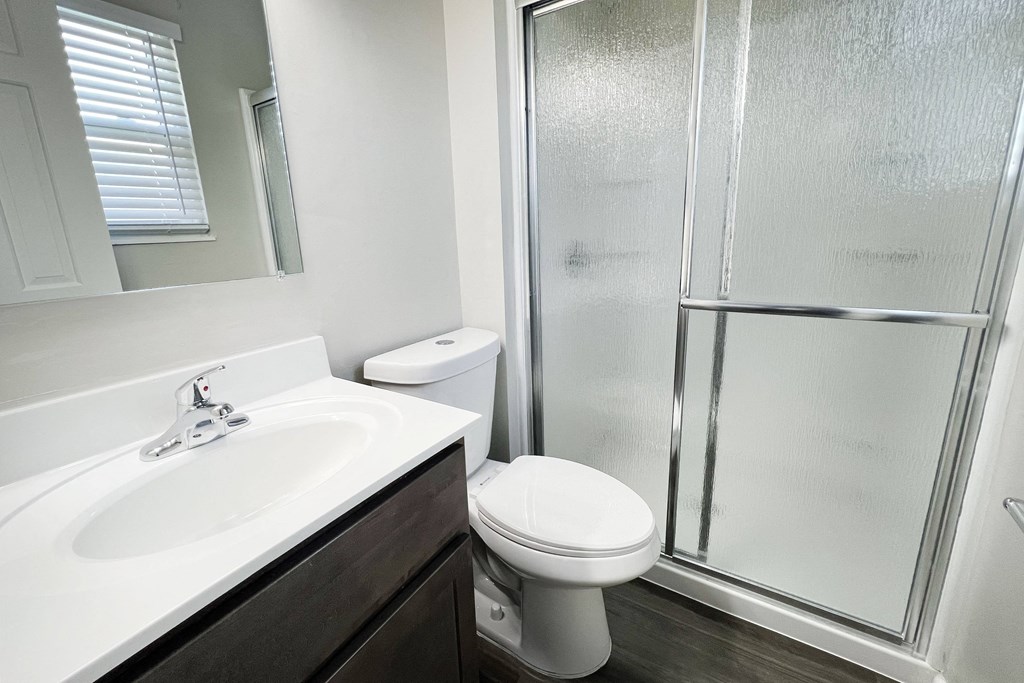 an empty bathroom with a shower toilet and sink at Revere Village Apartments, Centerville, OH, 45458