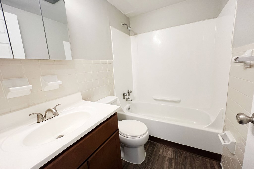 A white sink and toilet in a bathroom.