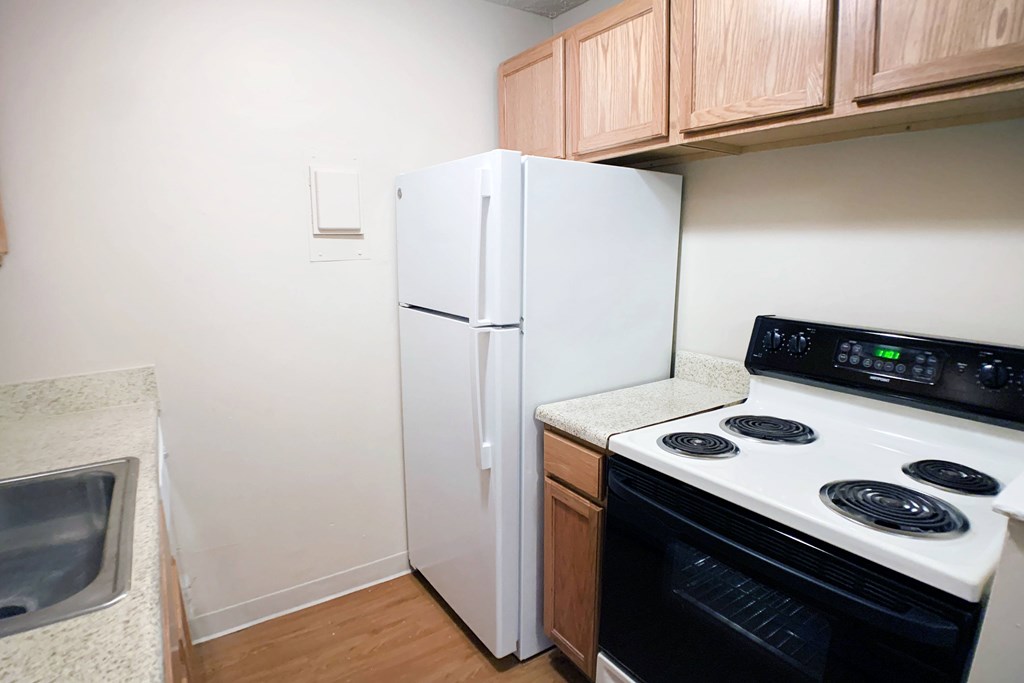 A white refrigerator and oven in a kitchen.