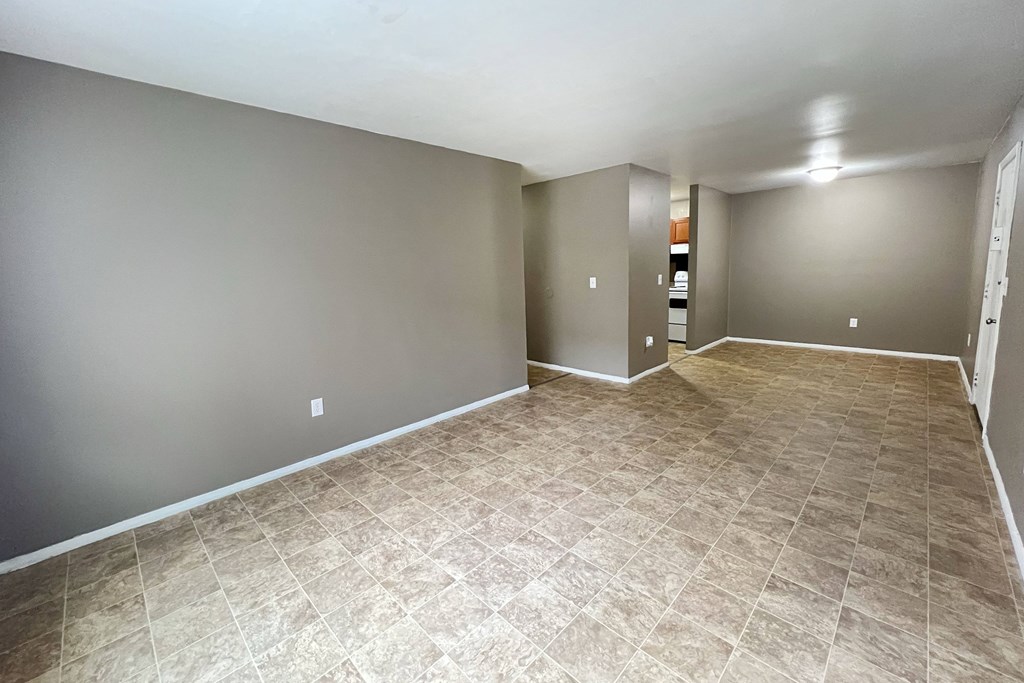 A room with a tiled floor and grey walls.