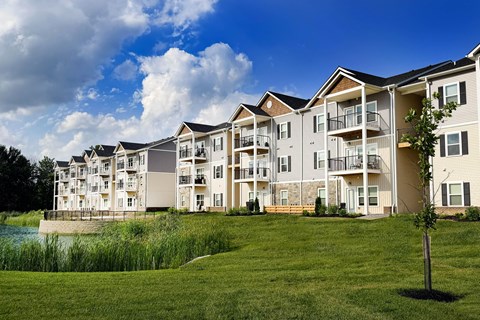 Apartment complex with a body of water in front.