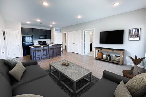 A modern living room with a grey couch and a coffee table.