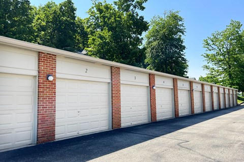 a row of white garage doors on a brick wall  at The Vinings Apartments, Cincinnati, Ohio