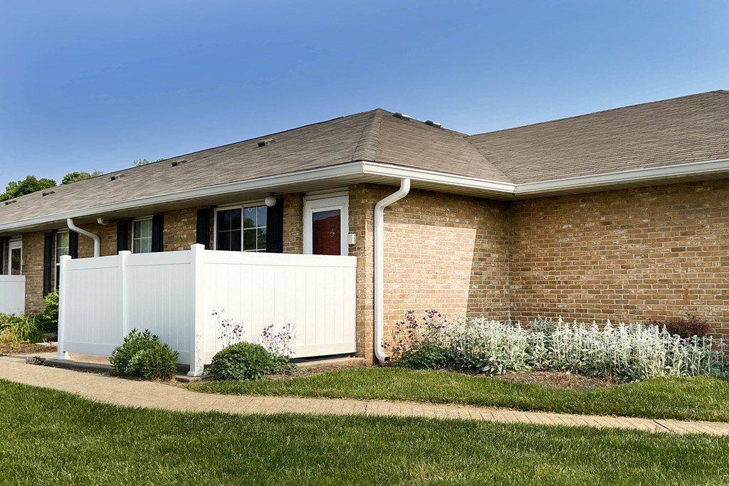 a house with a white fence in front of it  at Wyndemere Apartments, Franklin, Ohio