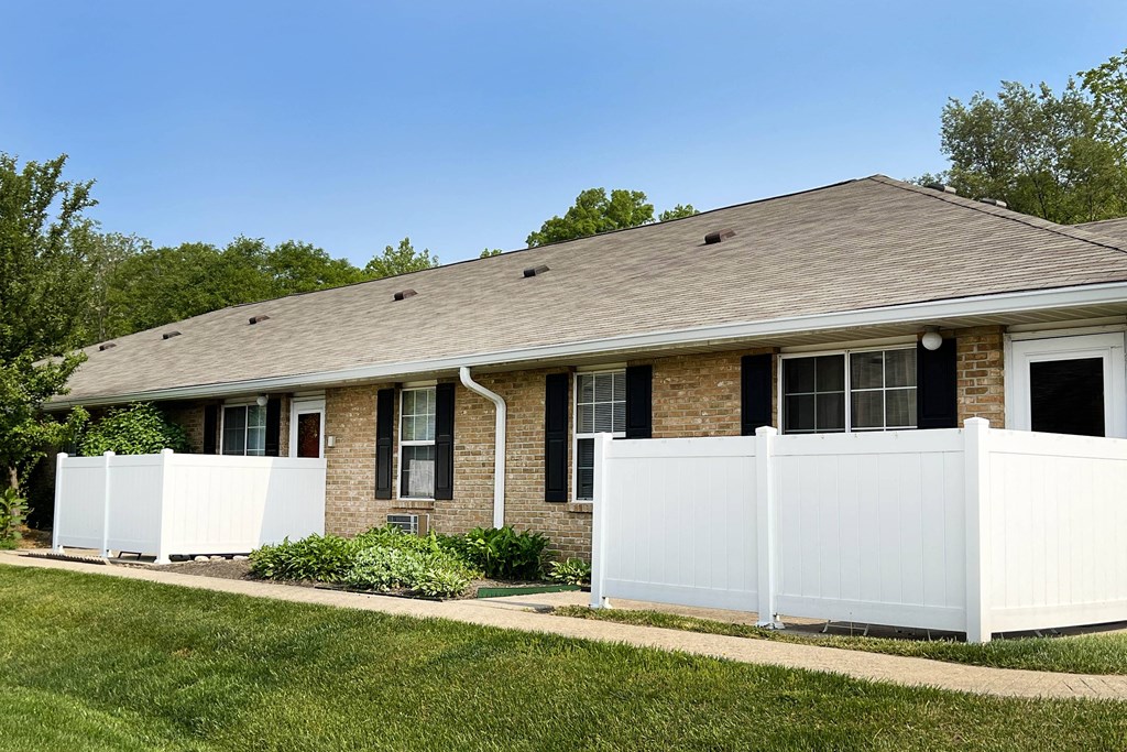 a house with a white fence in front of it  at Wyndemere Apartments, Ohio