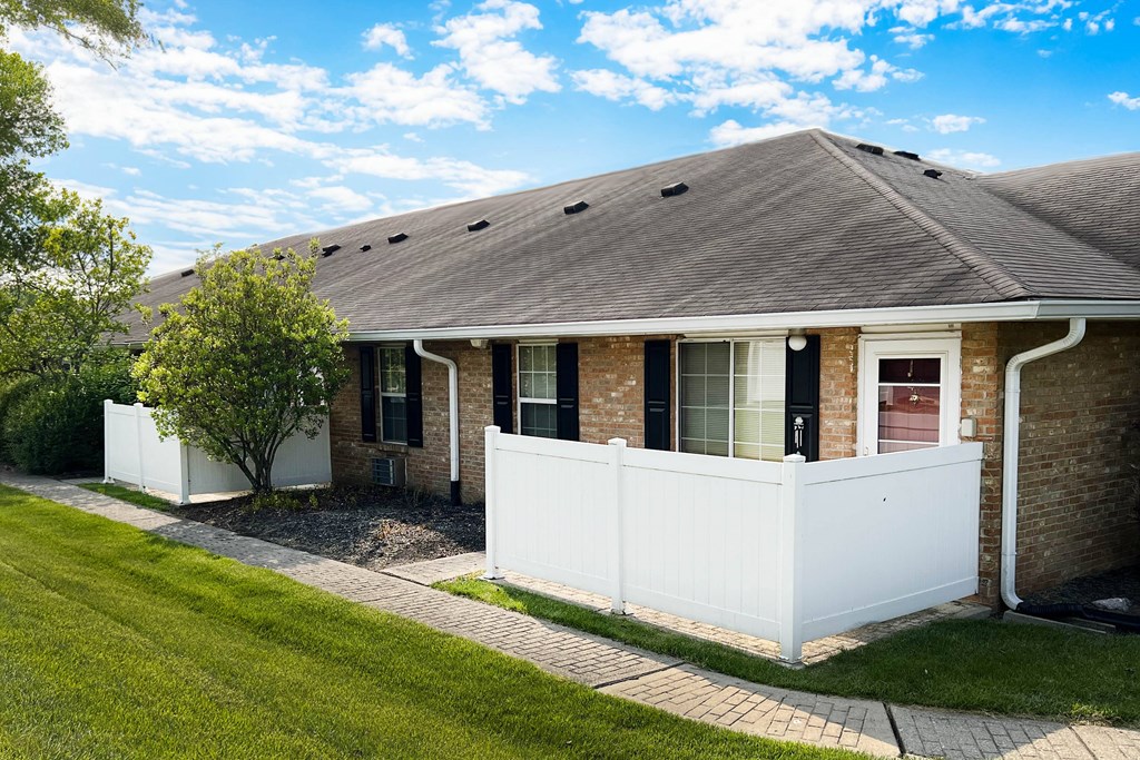 a house with a white fence in front of it  at Wyndemere Apartments, Franklin, OH