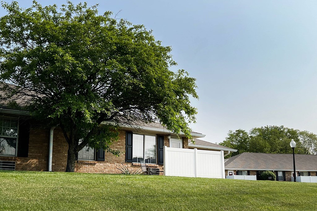 a house with a white fence in front of it  at Wyndemere Apartments, Ohio, 45005