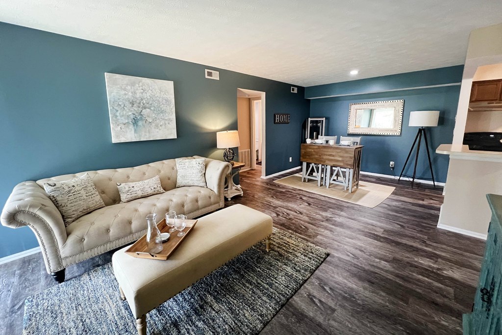 a living room with a couch and a coffee table  at Steeplechase Apartments, Loveland