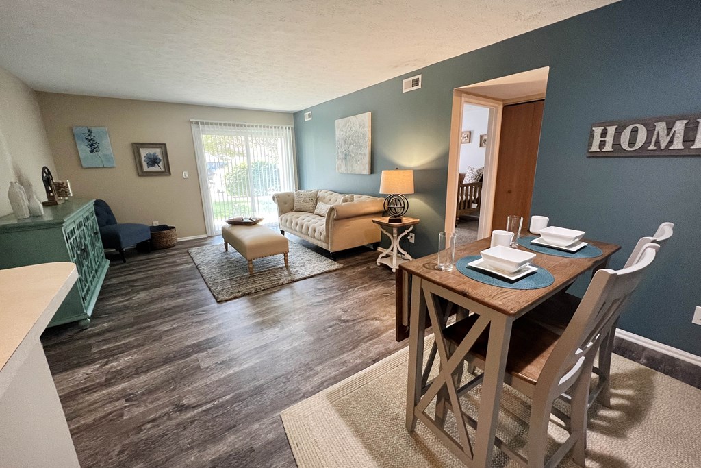 an open concept living room with a dining room table and chairs  at Steeplechase Apartments, Loveland, Ohio