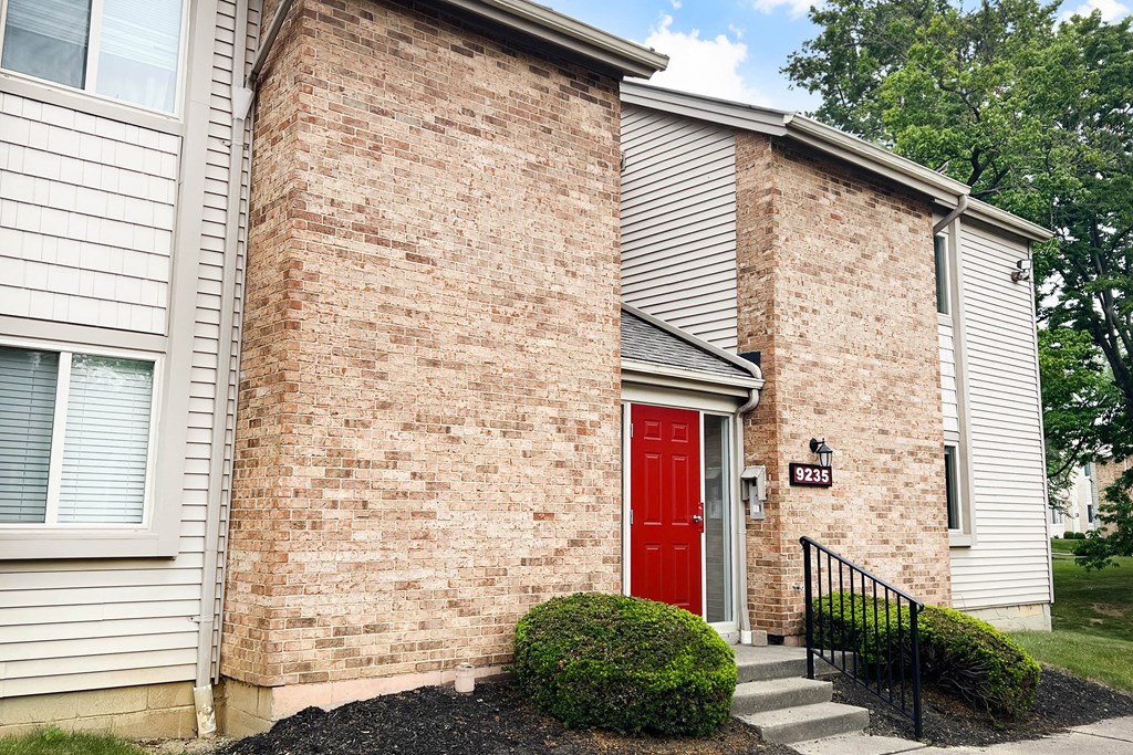 a red door on a brick building  at Hunter's Creek Apartments, Ohio, 45242