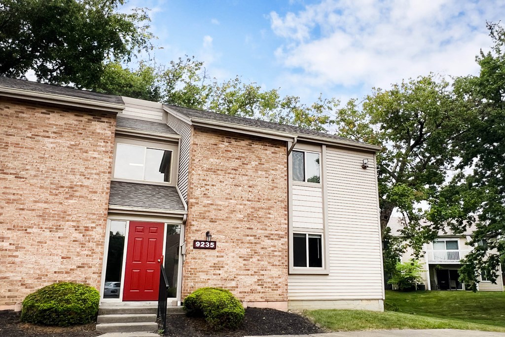 a red door on a brick building  at Hunter's Creek Apartments, Ohio, 45242