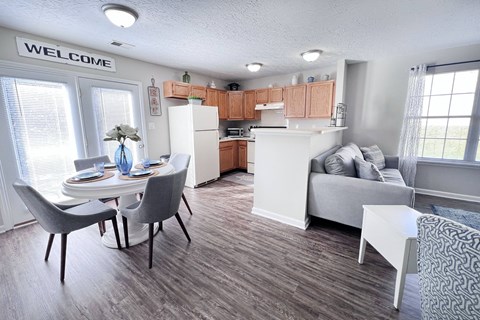 A kitchen with a dining table and chairs.