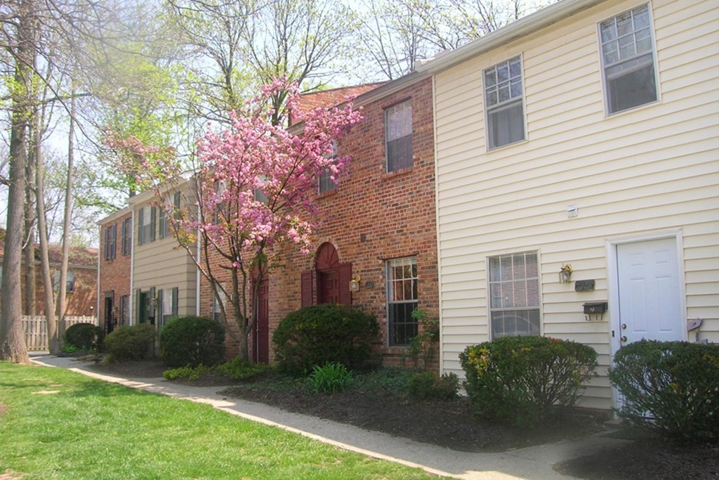 a side view of a house with a pink flowering tree at Walnut Creek Townhomes, Ohio
