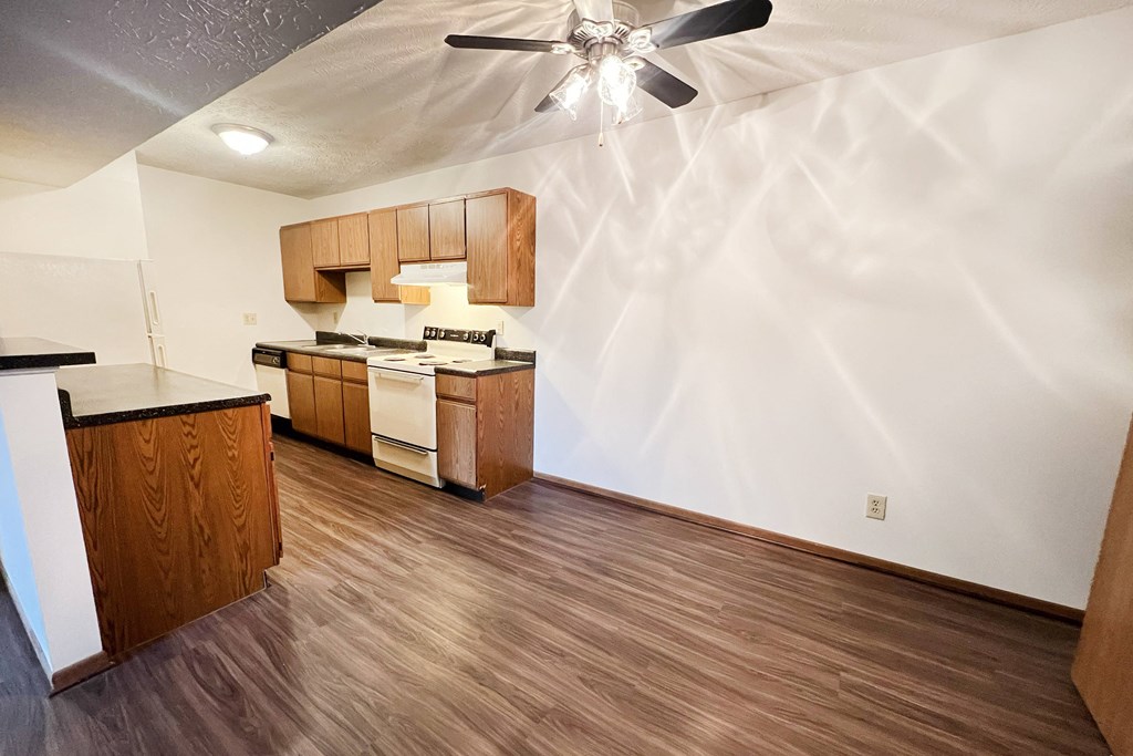the view of a kitchen and living room with wood flooring and a ceiling fan at Forest Creek Apartments, Middletown, OH 45044