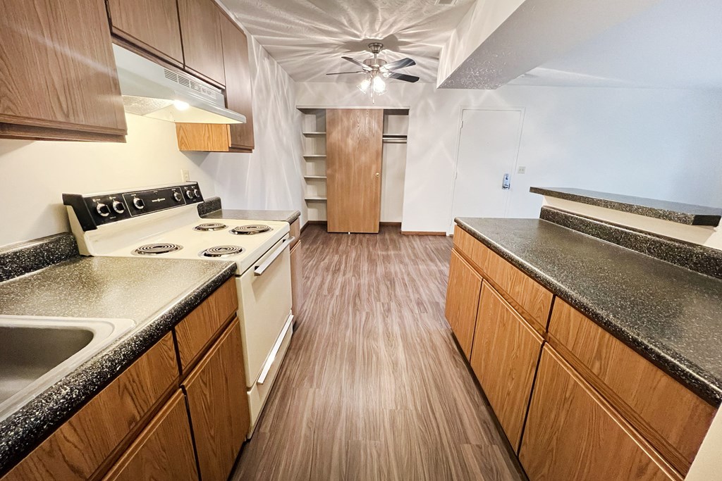 a kitchen with wood flooring and granite counter tops at Forest Creek Apartments, Middletown, Ohio 45044