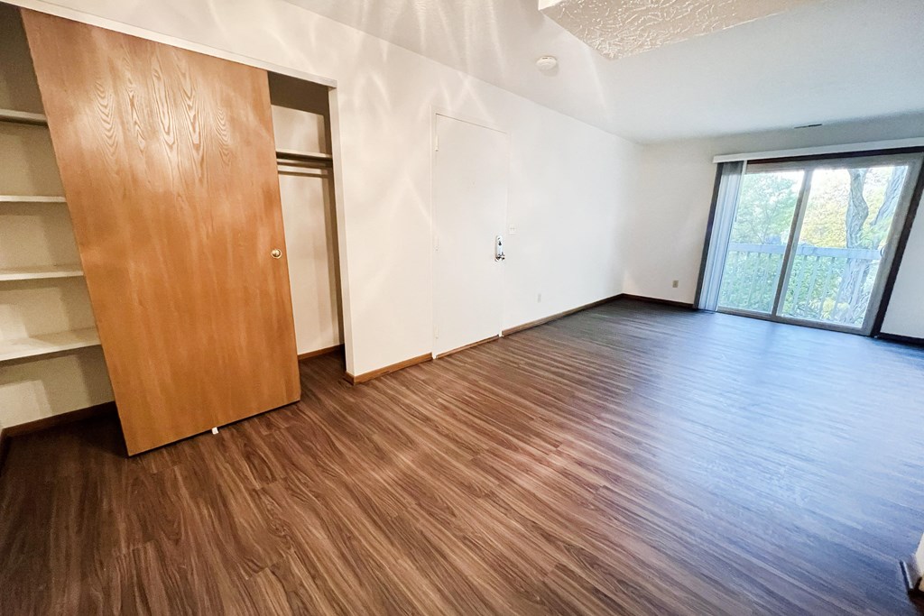 an empty living room with wood flooring and a closet at Forest Creek Apartments, Middletown, Ohio 45044