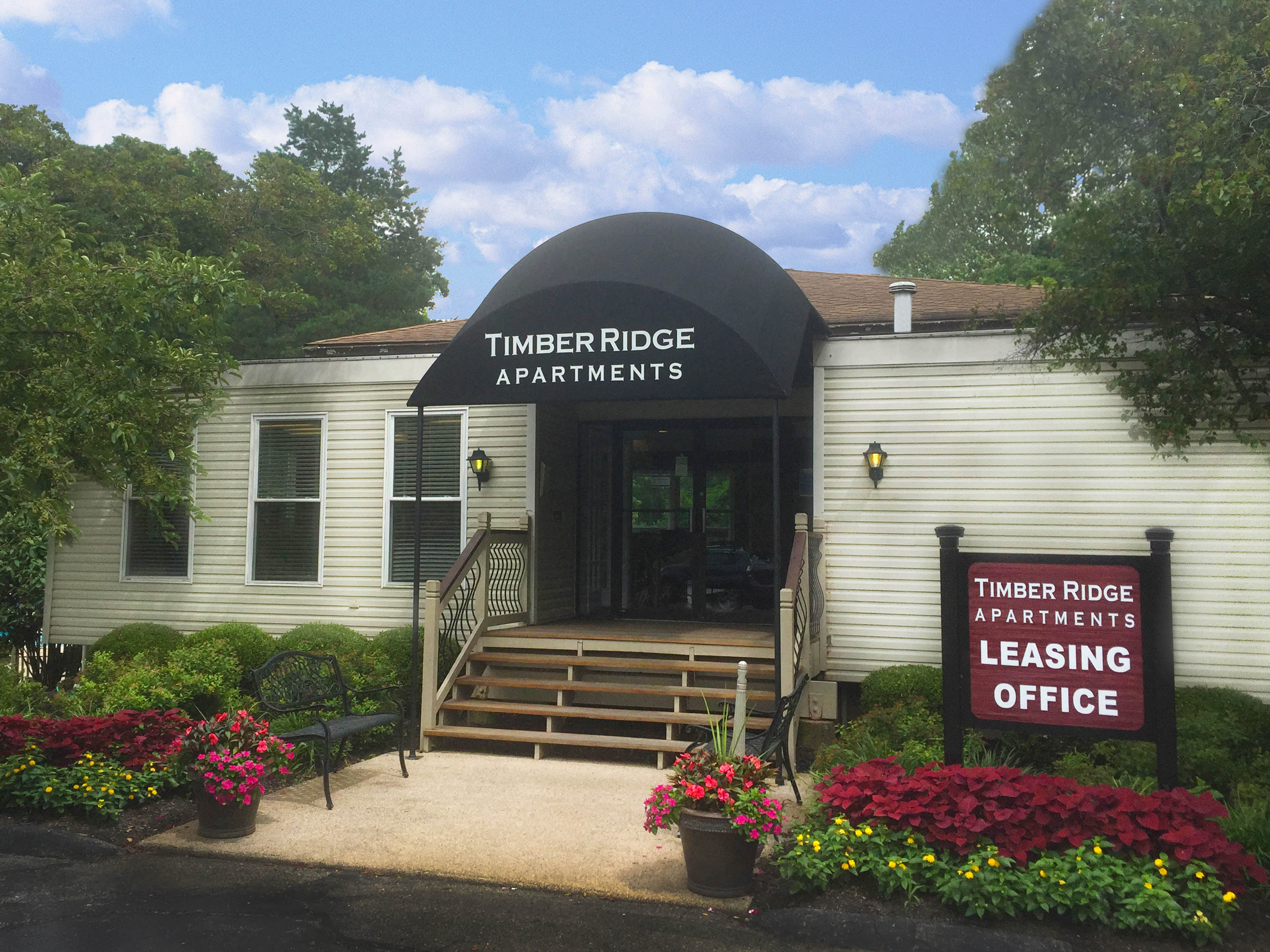 a white building with a sign that reads apartments leaseing office  at Timber Ridge Apartments, Cincinnati, Ohio