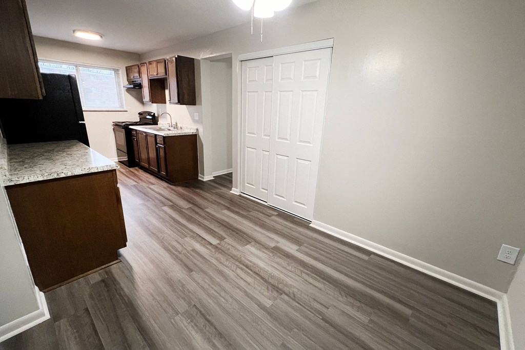 an open kitchen and living room with wood flooring in a home at Crown Court Apartments, Florence, KY