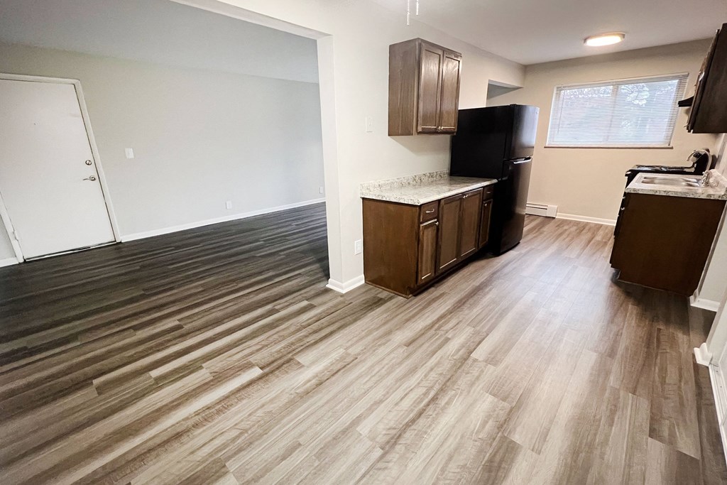 an empty kitchen and living room with wood flooring at Crown Court Apartments, Kentucky, 41042