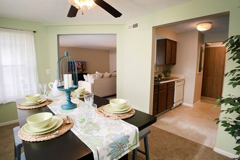 a dining room and living room with a table and chairs at The Vinings Apartments, Cincinnati, 45245