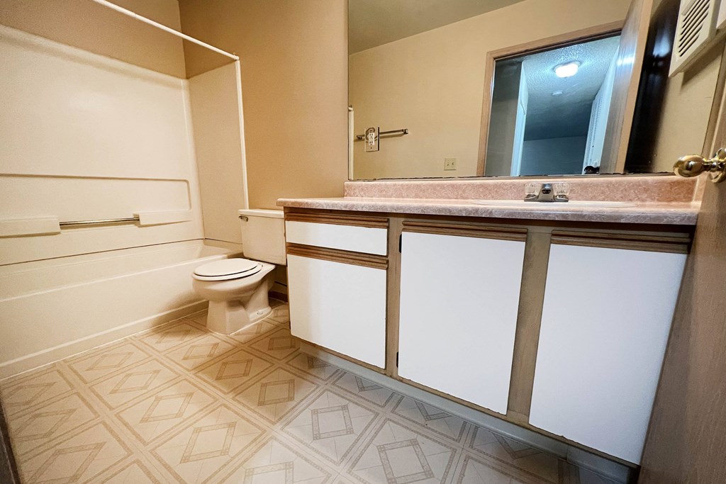 a bathroom with a toilet and a sink at Eagle Crest Apartments, Galloway, OH 43119