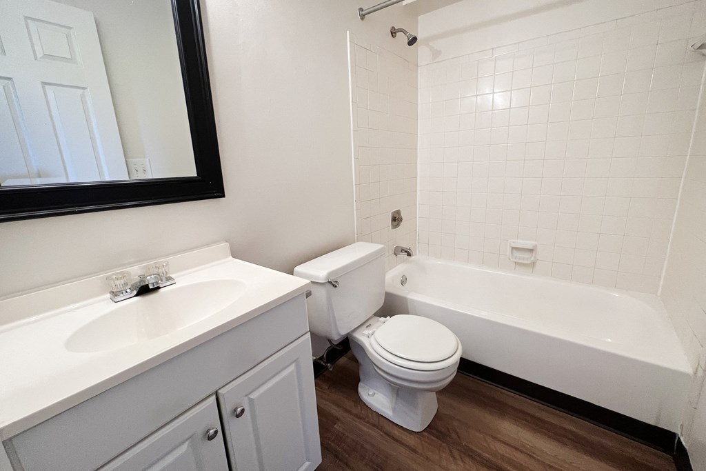 an empty bathroom with a toilet and a tub and a sink  at Crown Station Apartments, Amelia, OH, 45102