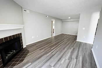 a living room with a fireplace and wooden floors at Deercross Apartments, Ohio, 45236