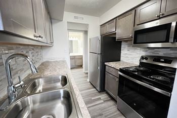 a kitchen with stainless steel appliances and granite counter tops at Deercross Apartments, Cincinnati, OH 45236