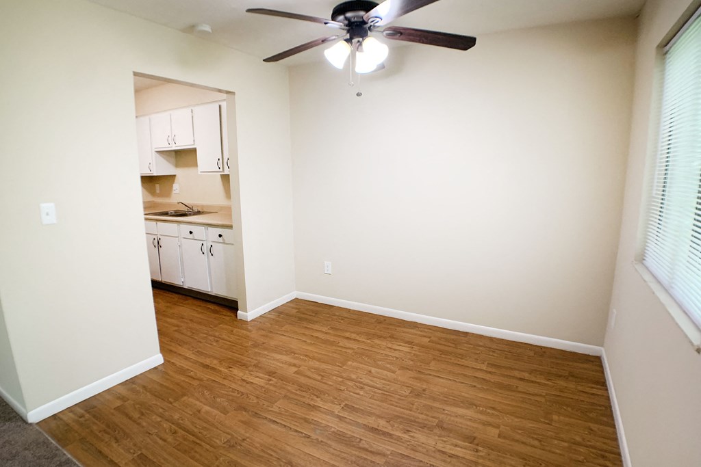 an empty living room with a wooden floor and a ceiling fan  at Hunter's Creek Apartments, Cincinnati, 45242
