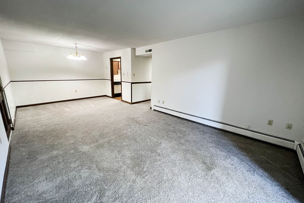 the living room of an empty house with white walls and a concrete floor  at Grace Court, Ft. Mitchell, 41017