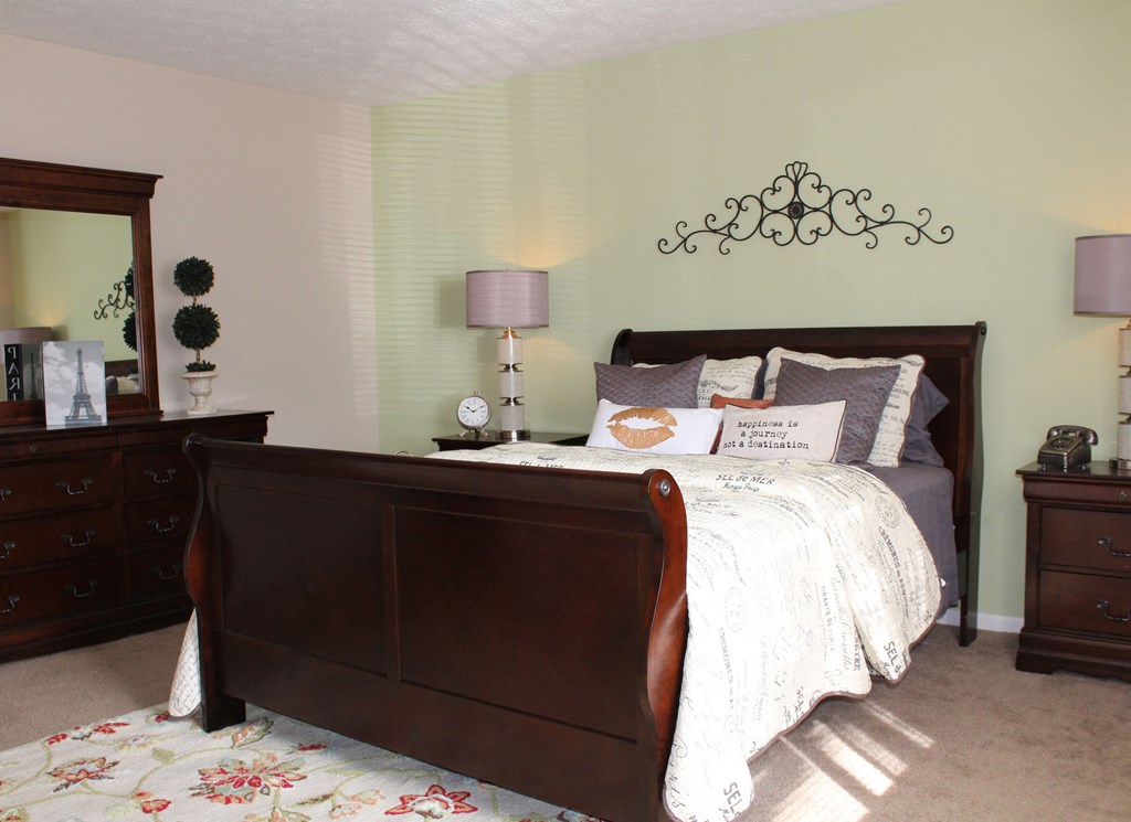 a bedroom with a bed and a mirror on the wall  at Hunter's Creek Apartments, Cincinnati, OH, 45242