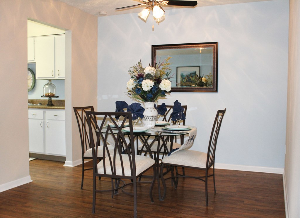 a dining room with a table and chairs and a ceiling fan  at Hunter's Creek Apartments, Ohio, 45242