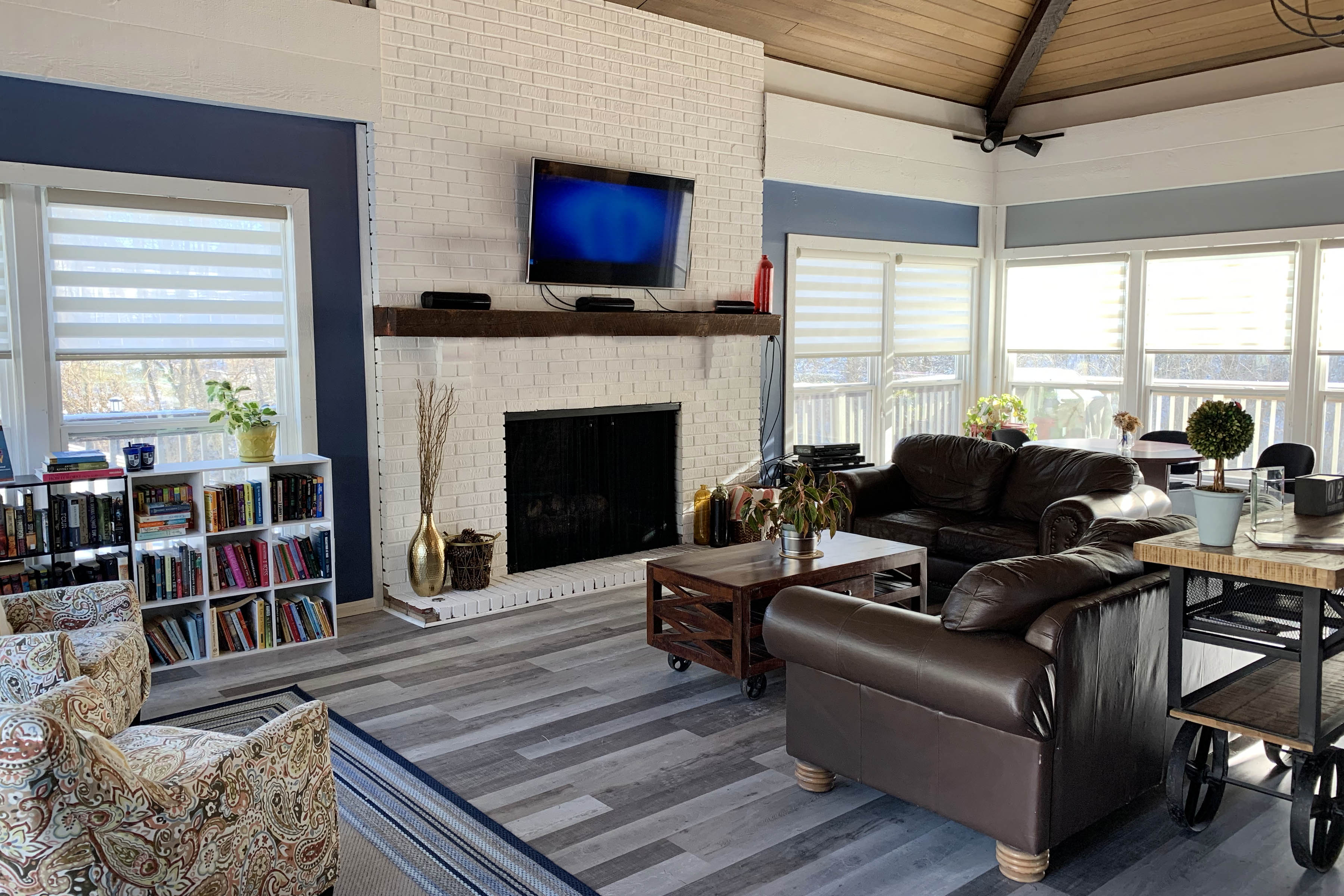 a living room with leather furniture and a fireplace